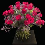 Großer Blumenstrauß aus roten Rosen mit violettem Strandflieder